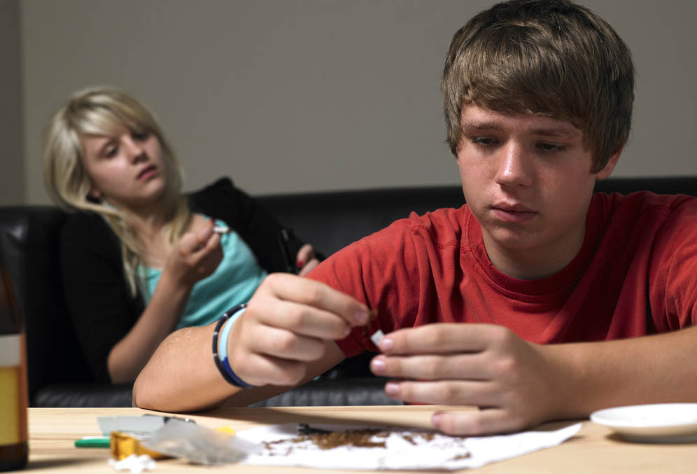 Two young teens using marijuana